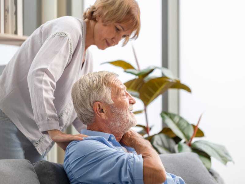 caregiver with hand on resident's shoulder